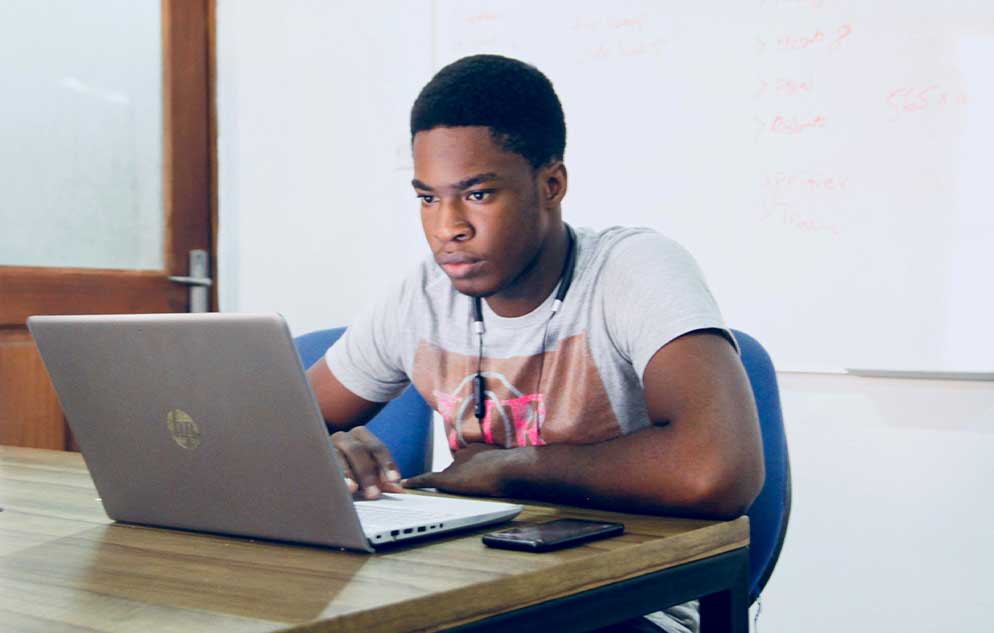 Student using a laptop in a classroom setting