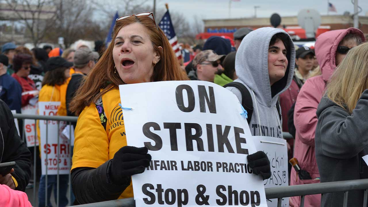 Protesters gathered at a labor strike advocating for fair labor practices.